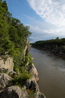 The Potomac River flowing past tree covered cliffs