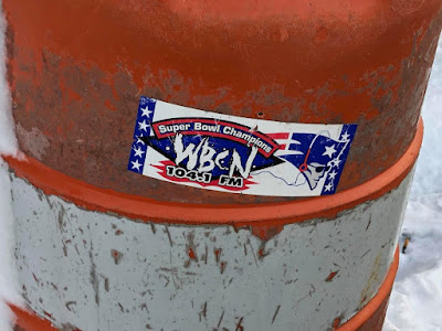 Patriots bumper sticker on orange barrel: "Super Bowl Champions - WBCN"