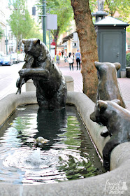 The sculpture of a mother bear and her cubs is part of a bronze sculpture & fountain series called "Animals in Pools" that was first installed in Portland, OR in 1986. 
