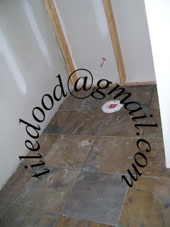 Slate floor installed around the toilet flange