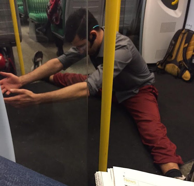 Commuter doing yoga on the train
