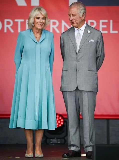 Queen Camilla wore a blue dress coat, and floral print midi dress. Diamond brooch. HMS Iron Duke