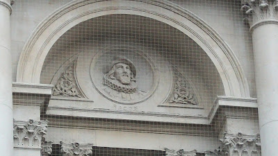 The face of Sir Francis Bacon, carved into (or out of) the side of a building.