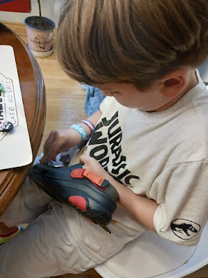 Boy adding charms to his Croc Shoes