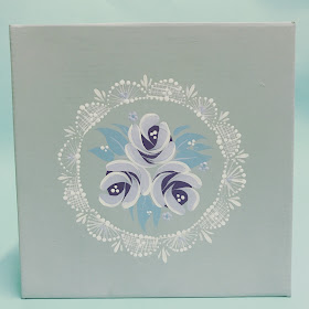 Hand painted gift box decorated with folk art style roses and a lace pattern