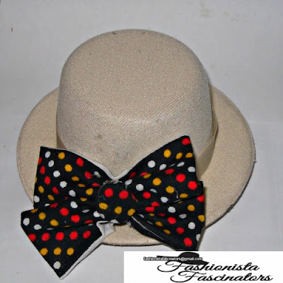 cream fascinator with a black bow tie with red, yellow and white polka dots Nairobi Kenya