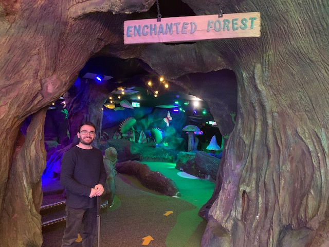 Man standing at entrance to Enchanted Forest crazy golf course