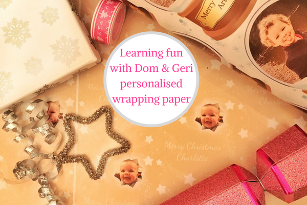 Dom and Geri personalised wrapping paper flatlay with xmas decorations