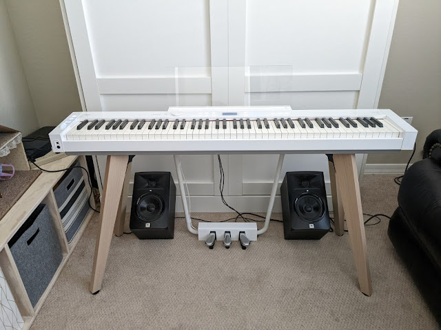 Casio PX-S7000 with 2 powered monitors under the piano