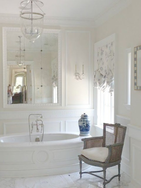 Luxurious bathtub and French inspired paneling in white Enchanted Home bathroom