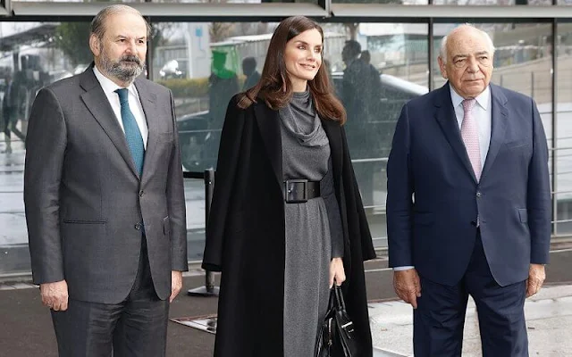 Queen Letizia wore a long scarf collar dress by Adolfo Domínguez. Letizia wore a wool black coat by Nina Ricci. Black suede boots