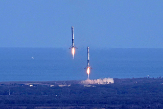 Jednocześnie powracające na Ziemię człony boczne rakiety Falcon Heavy lądujące pionowo w wyznaczonych strefach - przełom w dziedzinie odzyskiwania rakiet i prawdziwie historyczna widokówka z 6 lutego 2018 roku. Credit: SpaceX