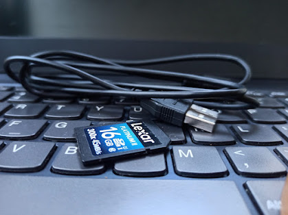 An image shows a USB cable and a DSLR memory card placed side by side.
