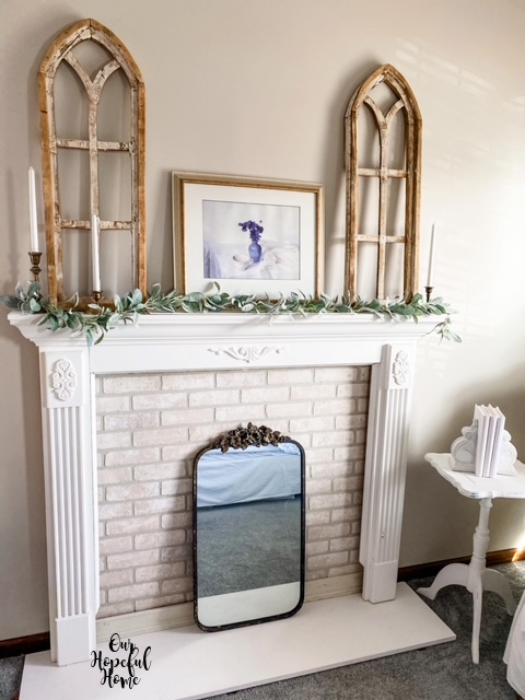 white faux mantel gold frame arch decor