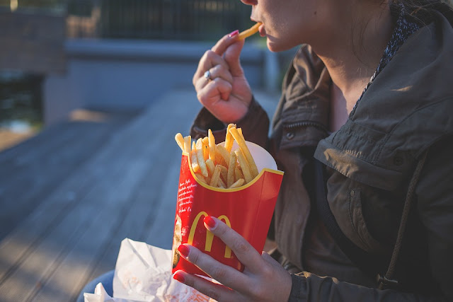 Image: Girl Eating McDonalds Fries, by Joanna Malinowska on FreeStocks