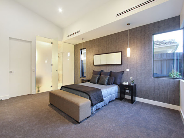 Picture of large brown bed in the master bedroom with brown wall
