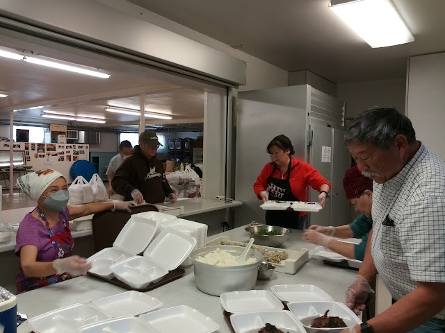 People preparing a take-out meal