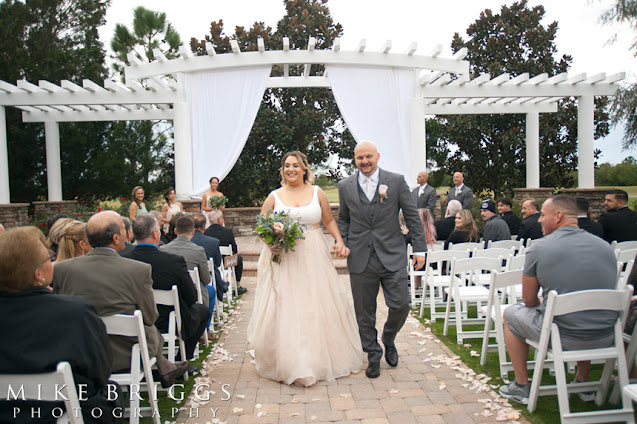 newlyweds walking down aisle together