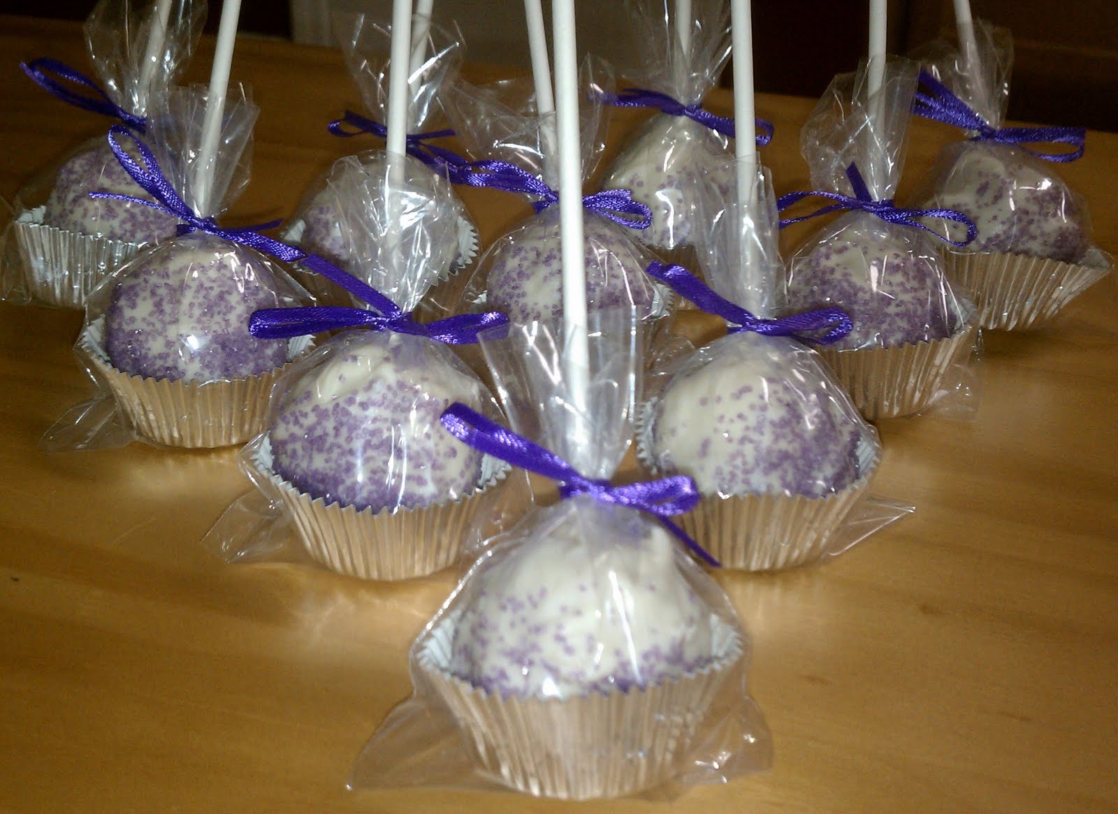 cake pops wedding display White Chocolate cake pops with purple sparkles.