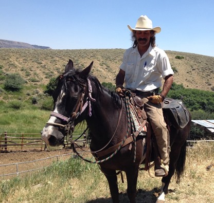 Maverick MAK on Candy behind the stable.