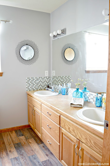 Adding updated flooring and a tiled shower to a builder basic master bathroom.