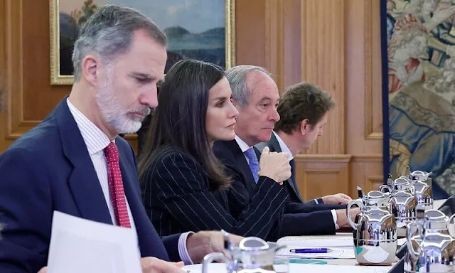 Queen Letizia wore a black striped suit, Kocani blazer and Aryisa pinstripe trouser, by Hugo Boss, and silk blouse by Hugo Boss