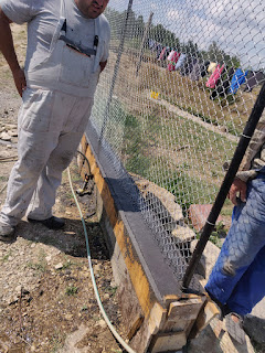 Halil just finished watering the hard concrete