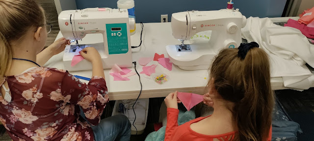 Kids sewing blocks for an Exploding Heart quilt