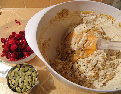 Half-Mixed Wet and Dry Ingredients, with bowl of Cranberries and bowl of Pumpkin Seeds