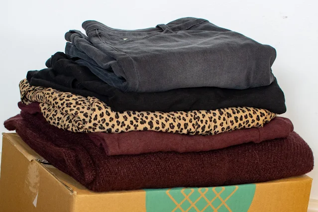 A box of clothes sent from Stitch Fix folded on top of the box