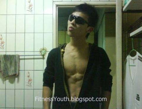 Asian Teen Bodybuilder flexing his muscular body at home 1