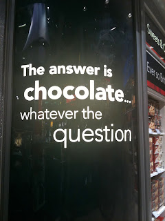 the answer is chocolate... whatever the question - signage at airport duty free shop 