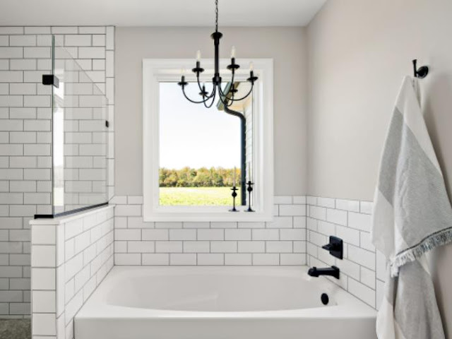 A Luxurious Farmhouse Bathroom With A Crystal Chandelier
