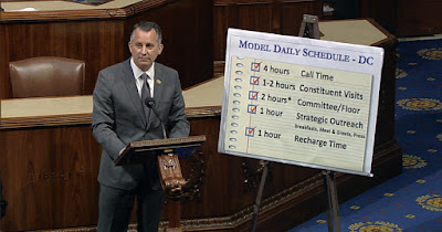 Former Rep. David Jolly in front of a placard that says four hours of call time