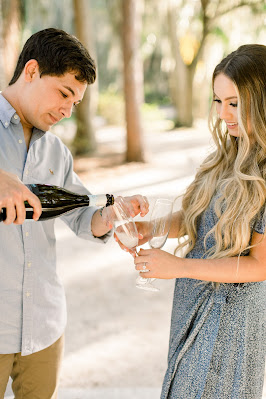 man pouring champagne for his fiance