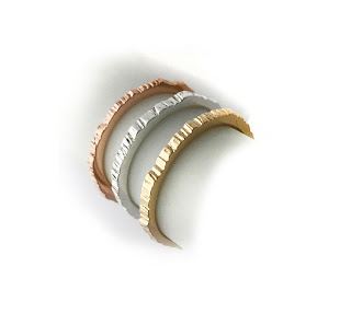 Rose gold, yellow gold, sterling silver, rings with a textured surface and high polish inside band. Shown on a white background