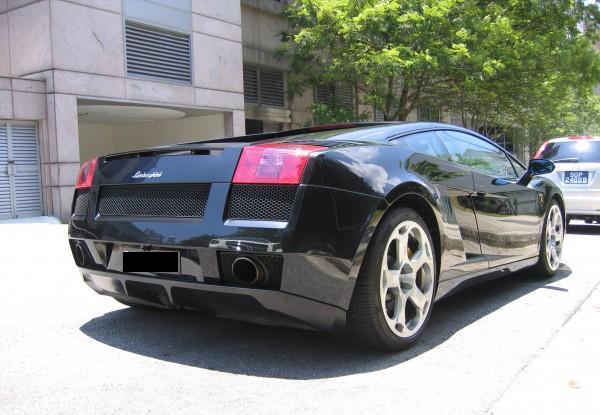 Black Lamborghini Gallardo parked down the street Just beautiful