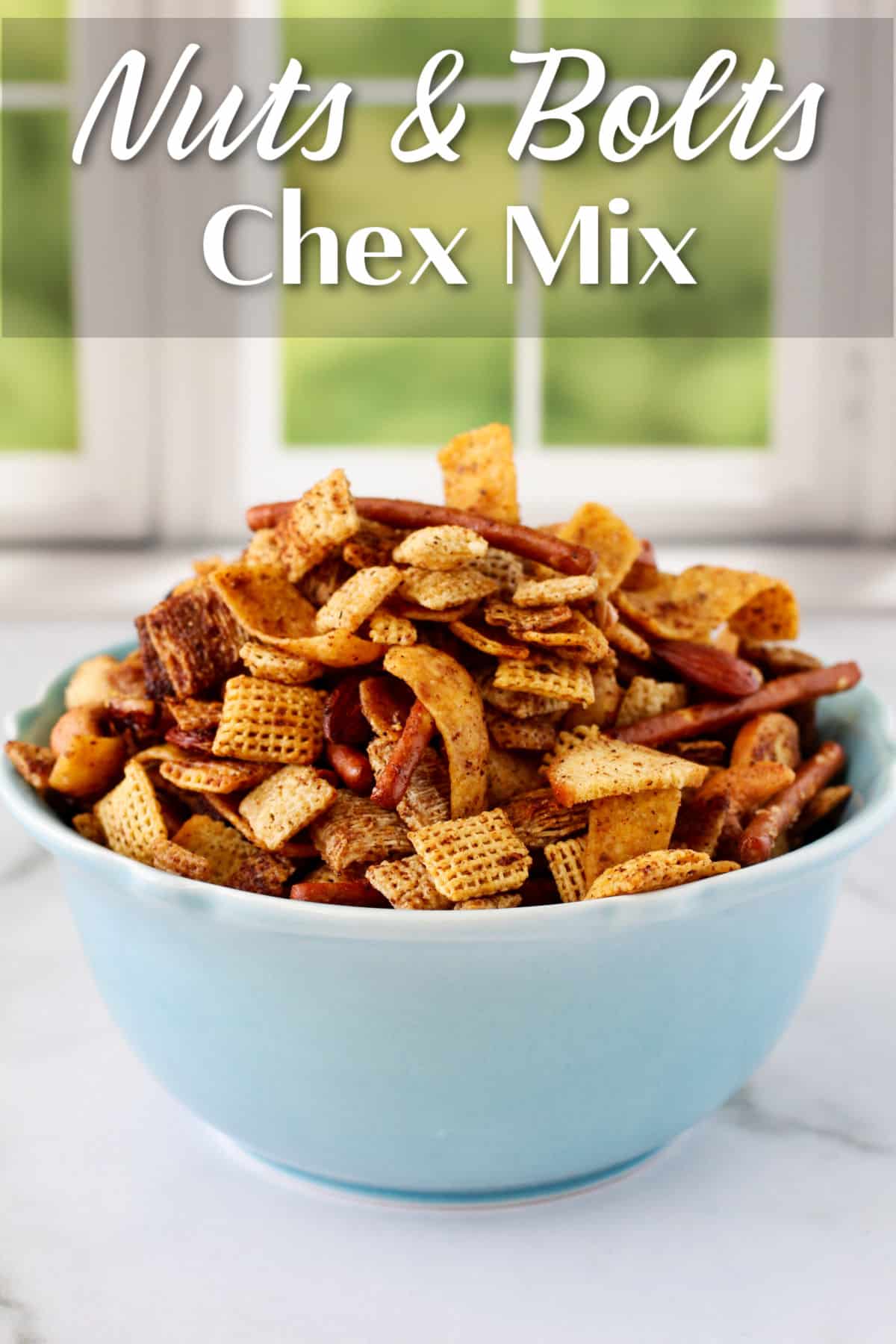 Nuts and Bolts Chex Mix in a blue bowl.