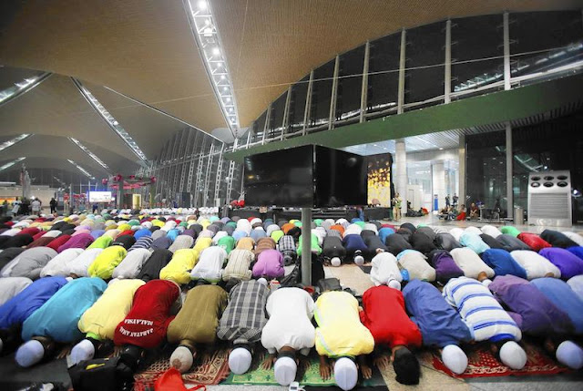 Muslim Men Praying in the Kuala Lumpur Airport