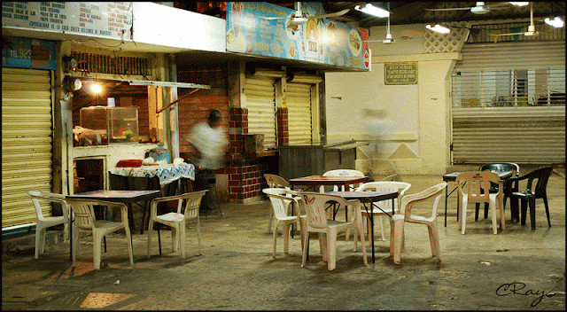 Merida Mexico food vendor stall closing for the night with empty tables