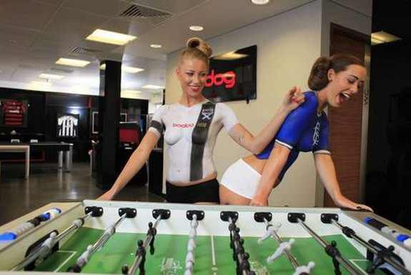 Two models in bodypaint 'wearing' Rangers & Ayr United kits