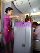 Thai Airways flight attendants do their job with a smile. (sam )