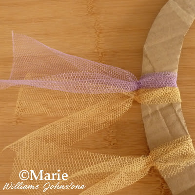 Purple and gold netting strips tied to wreath