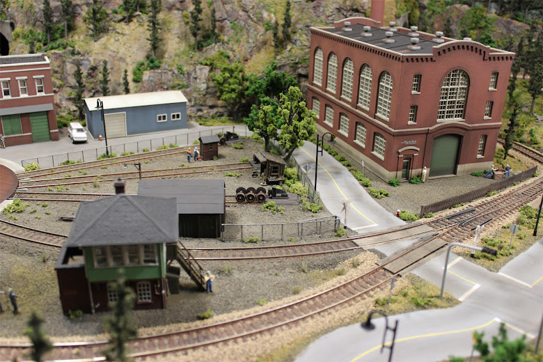 Industrial and railyard scene with grade crossings, turnout, signal tower and Northern Light & Power Co. kit
