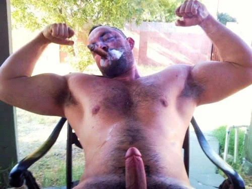 Cigar muscle bear blowing thick cigar smoke while flexing muscles
