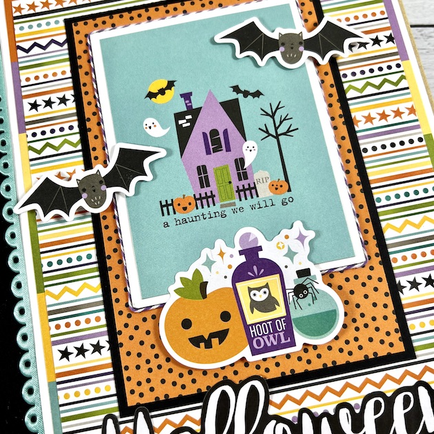 Halloween scrapbook album with haunted house, pumpkin, bat and potion stickers