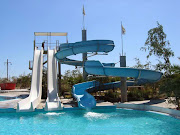 The Water Park consists of three swimming pools surrounded of sun beds and . (water park)