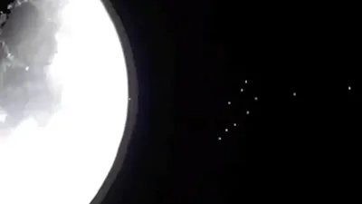 Huge group of UFOs coming away from the Moon.