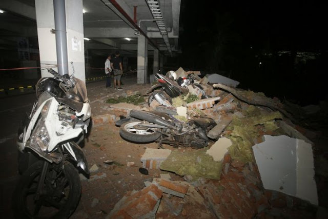 Debris on top of a motorcycles after an earthquake in Bali, Indonesia on Sunday 