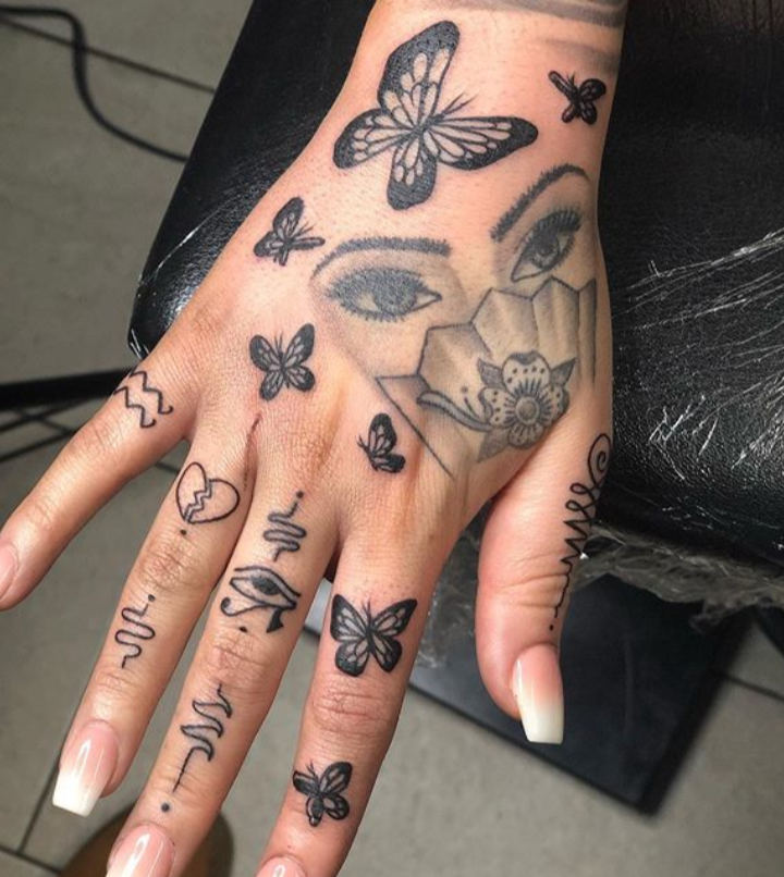 Butterfly tattoo on hand for girl with face